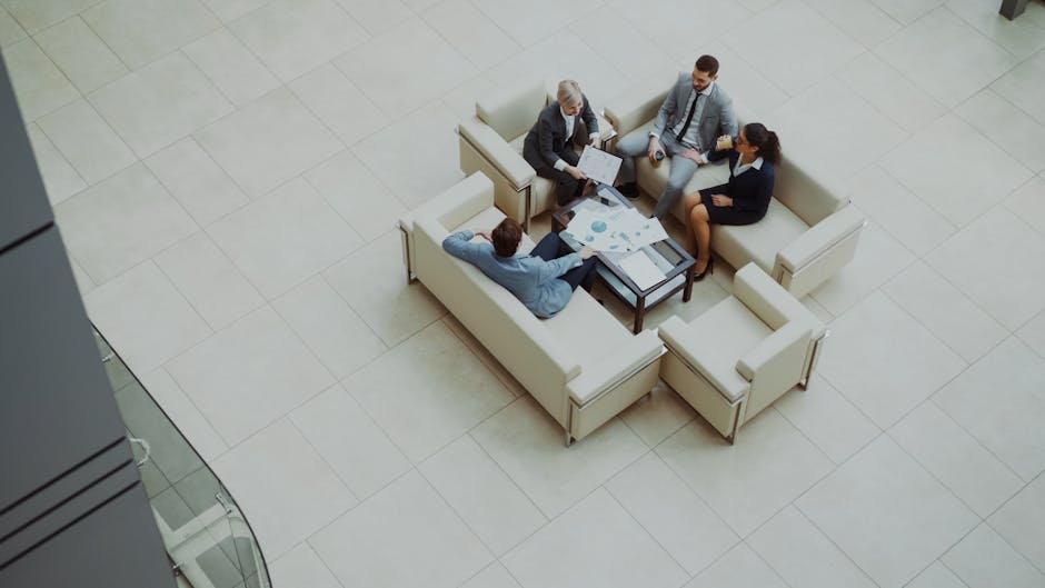Aerial view of a group business meeting in a modern office setting.