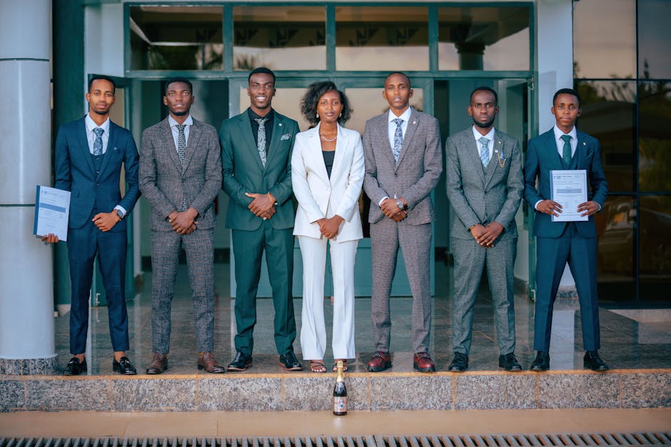 A group of business professionals in suits standing confidently outdoors, embodying teamwork and diversity.